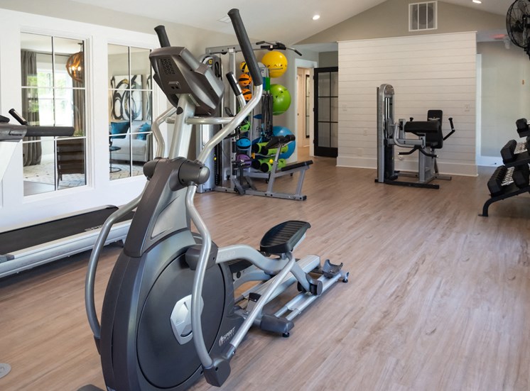elliptical, treadmill, free weights, and yoga equipment in fitness center