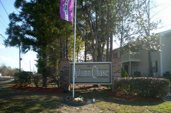 entrance signage and flag at Autumn Chase Apartments