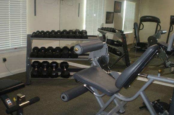 fitness center with weight machines and free weights