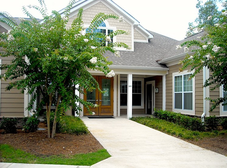 leasing office and clubhouse exterior with crepe myrtles