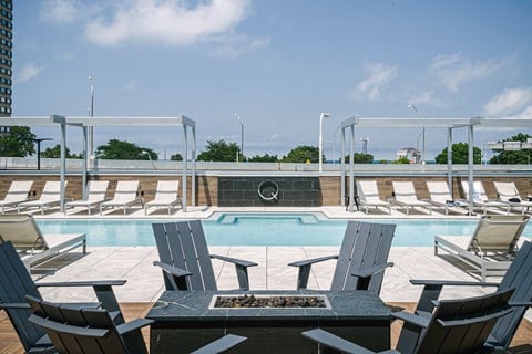 Quarter residents enjoy a heated zero-edge pool with cabanas and grills on a raised deck
