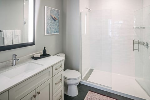 Quarter baths feature a glass shower enclosure and subway tile