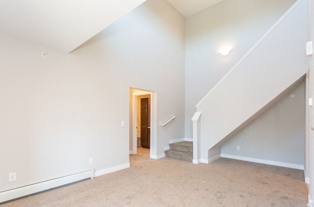 A room with a staircase and a door.