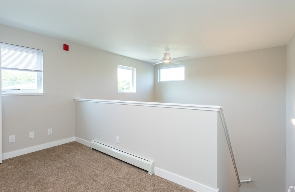 A room with white walls and a window.