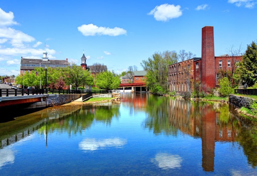 a river running through a city with buildings and trees
