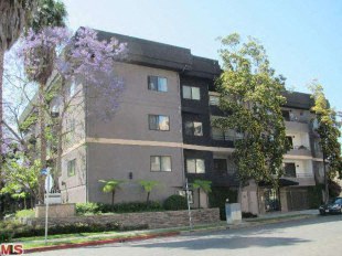 Apartment building with a car parked in front at Twelve One Ten Rochester, California 90025