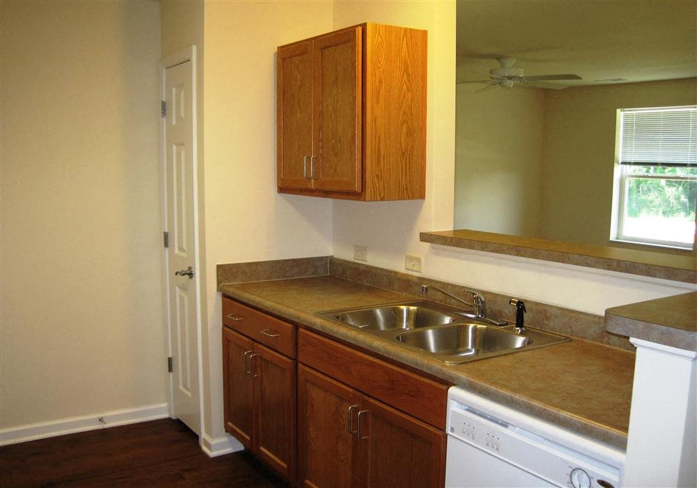 Kitchen, wood floors, wooden cabinets, extended sink and pantry