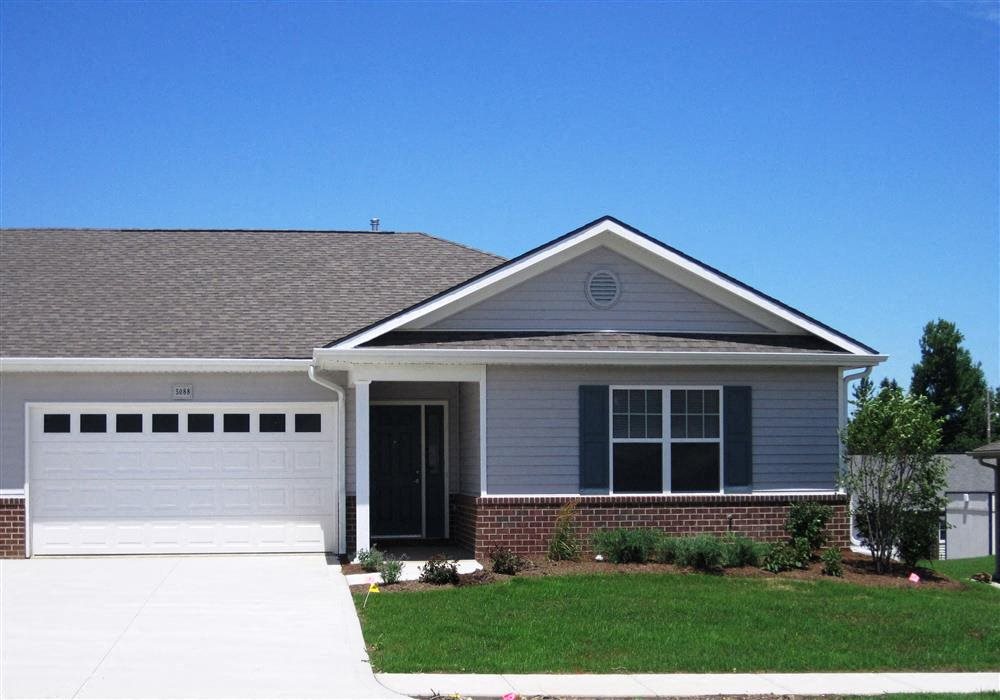 Exterior of Apartment home, brick and blue colored home with manicured green landscaping