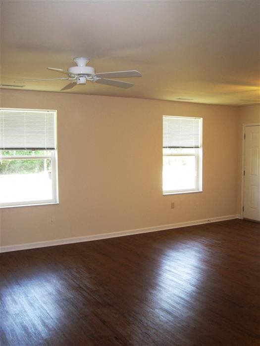 Bedroom, wood floors, large window and blinds