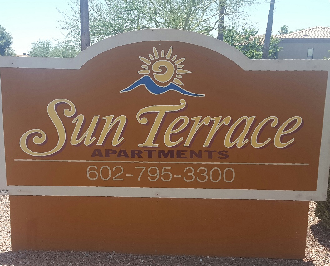 Community sign at Sun Terrace Apartments.