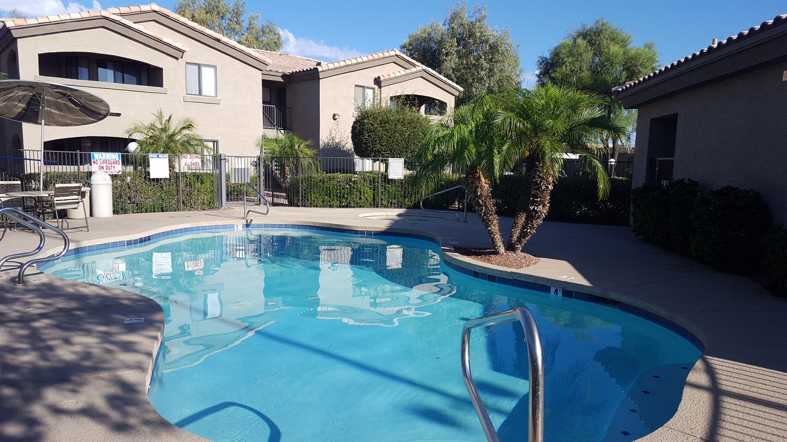 Pool and poolside area at Sun Terrace Apartments.