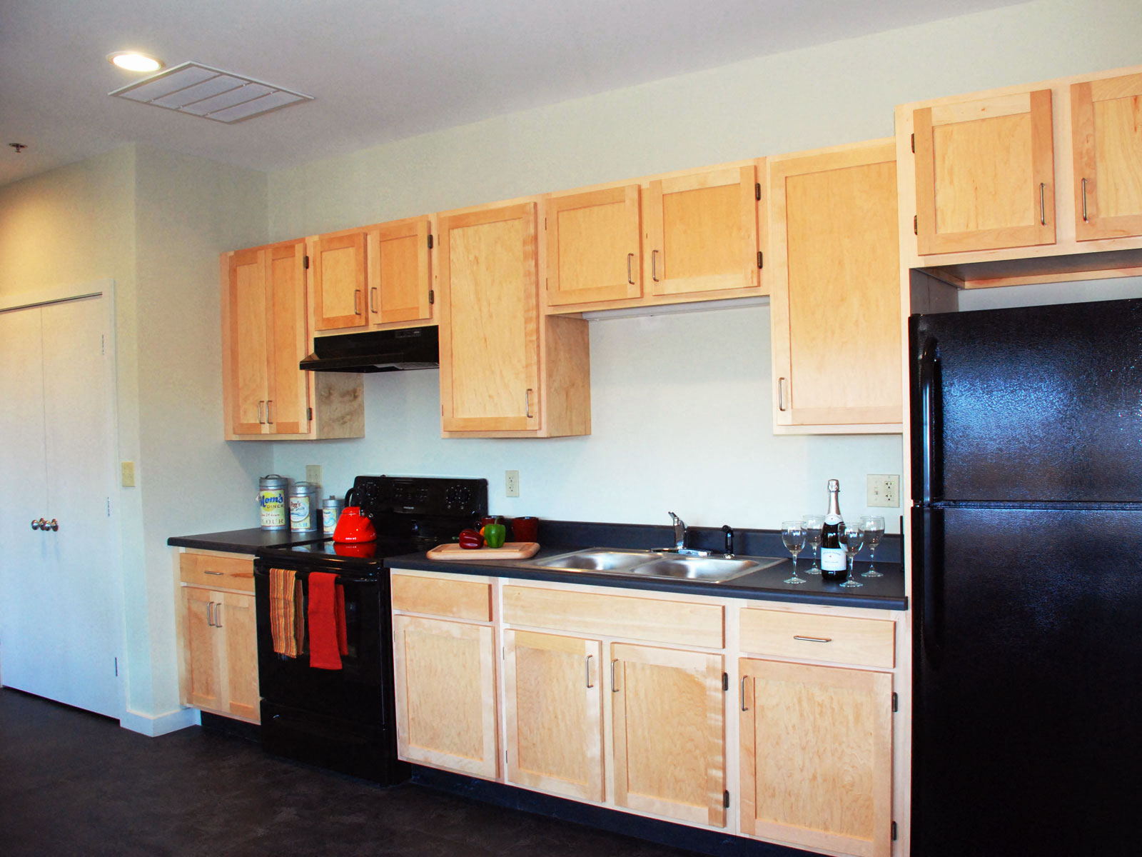 Kitchen with black appliances and plentiful cabinets