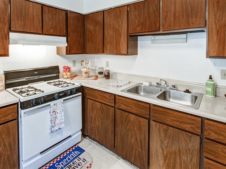 Kitchen with white appliances and plenty of cabinetry for food and kitchen utensil storage
