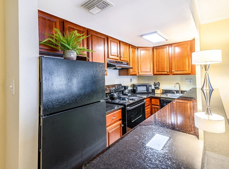 Studio apartment kitchen with granite countertops at The Georgian in New Orleans