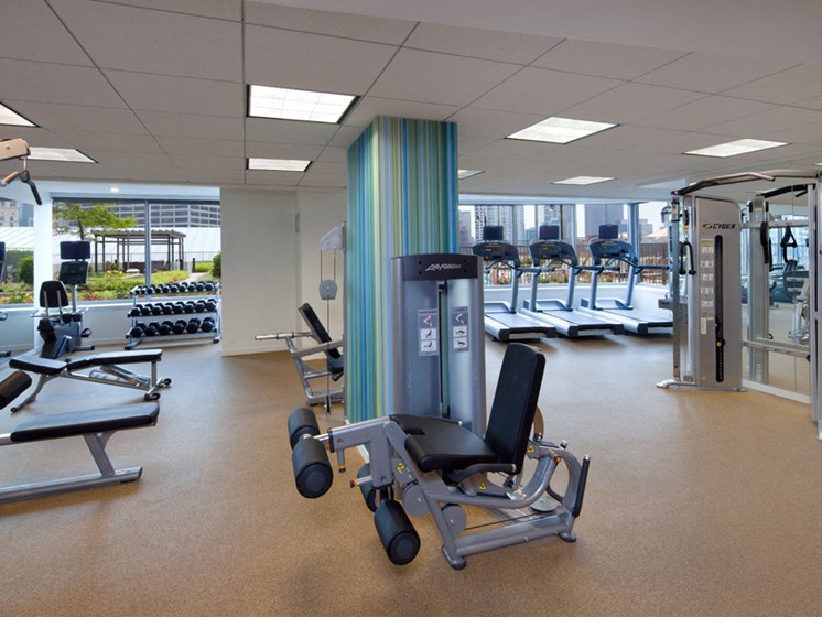 Kingsbury Plaza's fitness center with cardio, free weights, and large windows with views of River North Chicago