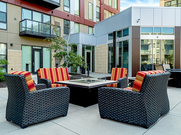 Patio seating surrounding a square fireplace table