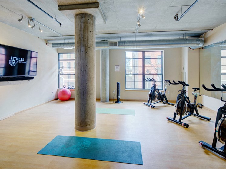Yoga studio with ellipticals and a TV