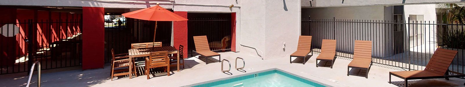 Swimming Pool Area With Shaded Chairs at City Park View, California
