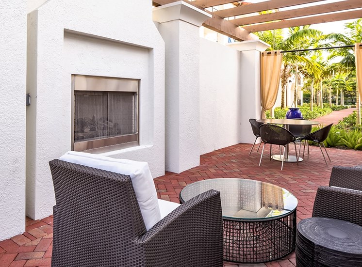 2940 Solano at Monterra apartments poolside outdoor lounge with fireplace in Cooper City, Florida