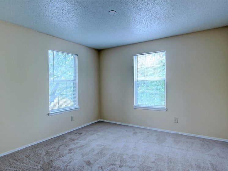 Image of large room with carpeting and windows