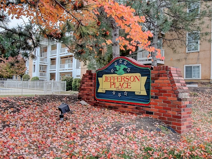 Image of Jefferson Place East sign with trees