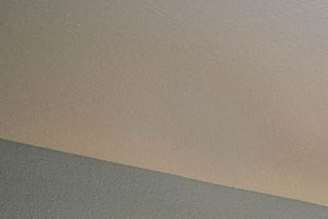 A bedroom with a bed, nightstand, and a ceiling fan.