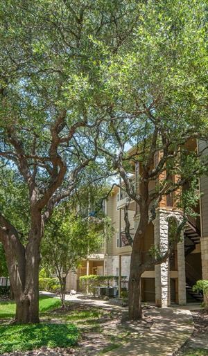 Austin TX Apartments - Exterior View of the Apartment Building Showcasing Large Community and Beautiful Landscaping