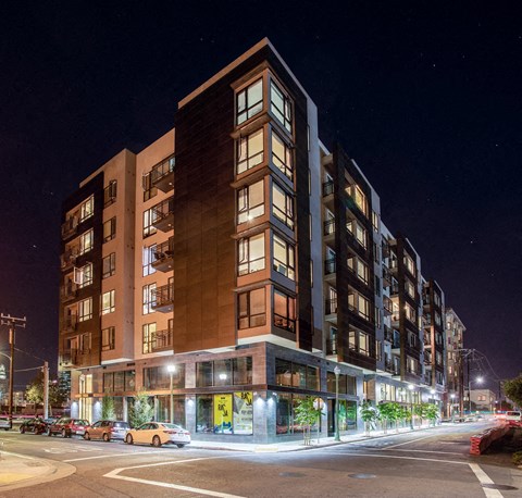 Luxury Apartments in Oakland CA - Exterior View of the Apartment Building at Night Showcasing Expansive Community