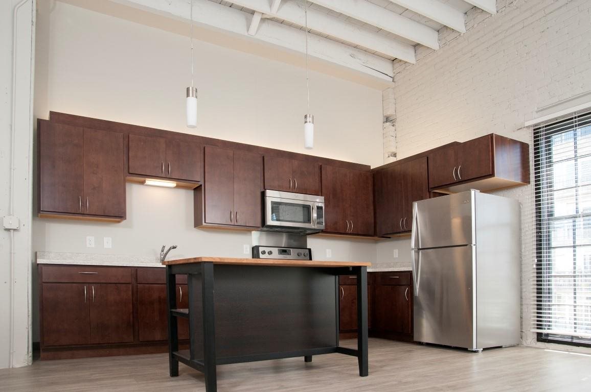 Kitchen with High Ceilings and New Appliances at Apartment in North Loop