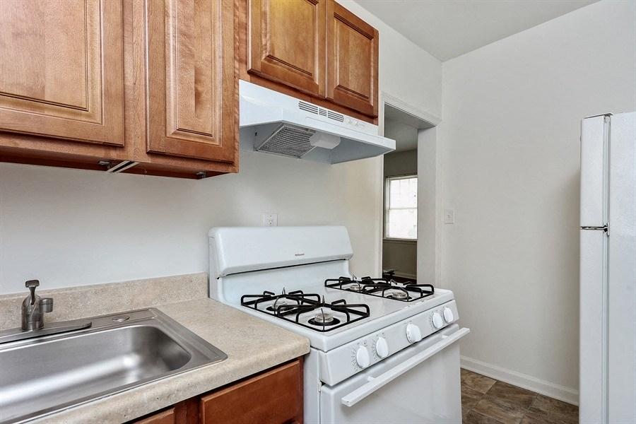 Apartments in Baltimore feature kitchens with appliances and updated cabinetry.