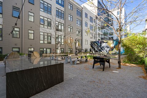 Gathering Area With Grills And Corn Hole at The Edison at Union Market, Washington, 20002
