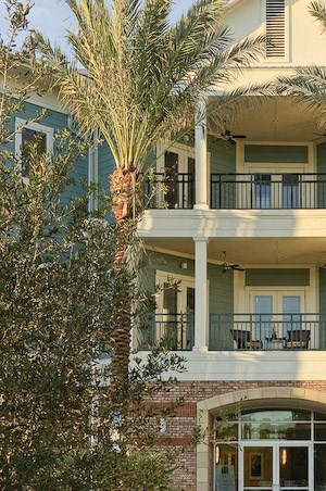 Exterior of Newberry, FL apartments with balconies and palm trees
