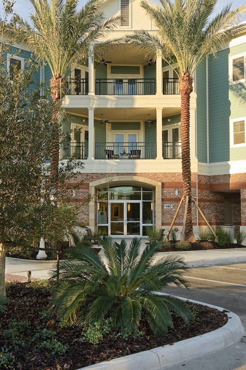 Exterior of Newberry, FL apartments with balconies and palm trees