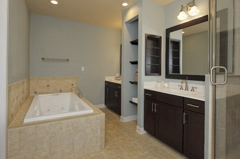 Large master bathroom with shower and spa bathtub at The Flats at Tioga Town Center