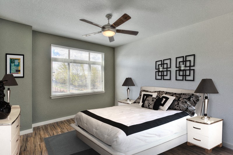 Village on Redwood interior bedroom with large window and ceiling fan