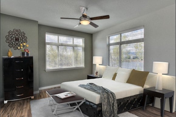 Village on Redwood bedroom with large windows and ceiling fan