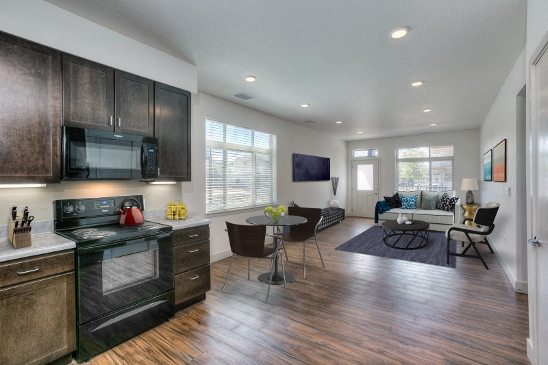 Village on Redwood kitchen with black appliances and modern wood cabinetry