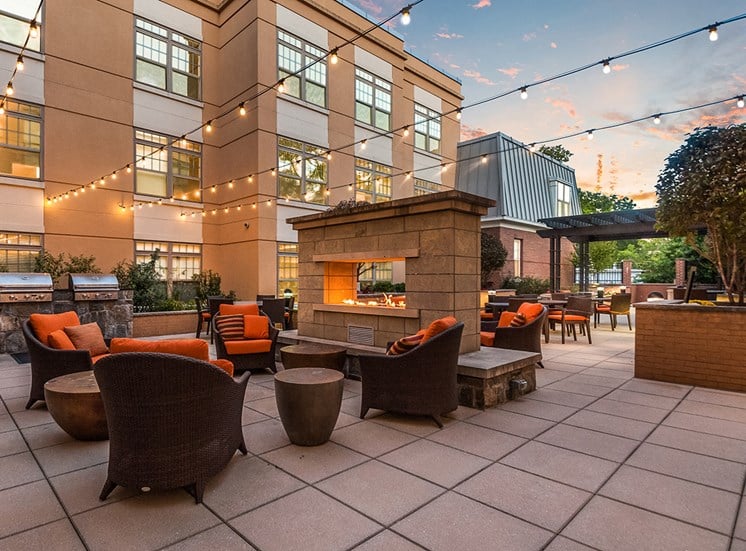 Charming courtyard with fireplace and BBQ grills at Northgate Apartments in Virginia