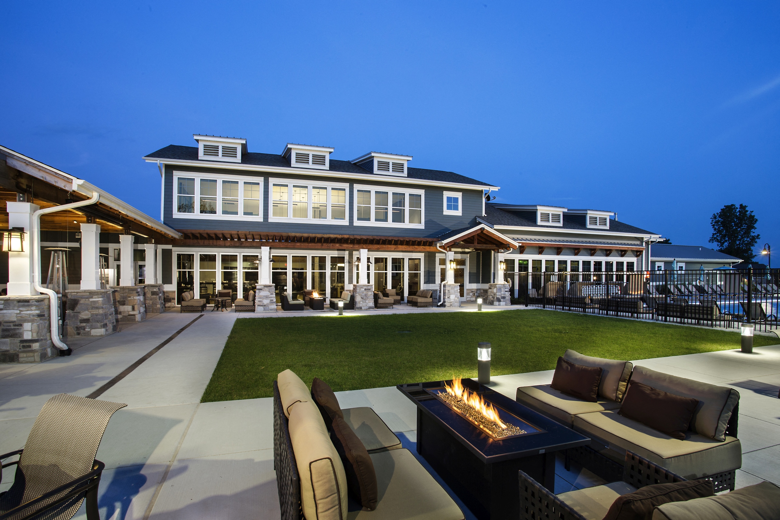 Outdoor seating area with patio couches and fire pits at The Lakes of Valparaiso
