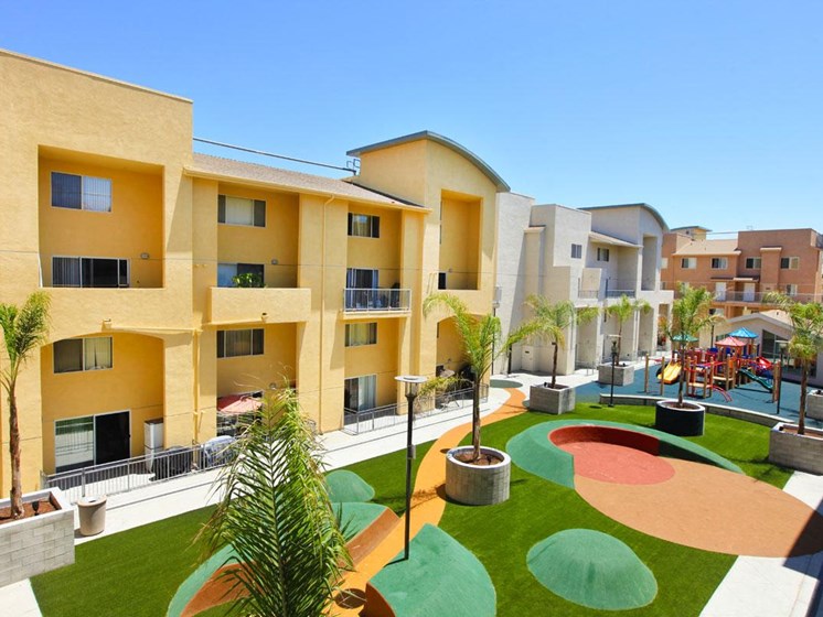 Community lawn and courtyard with yellow and light gray community exterior.