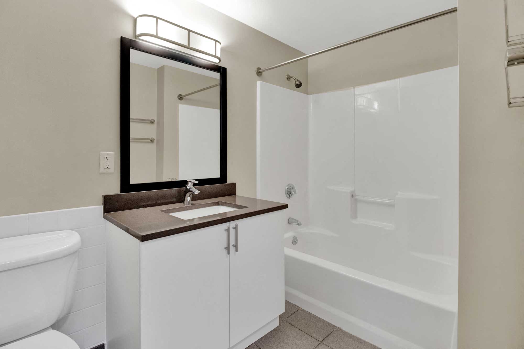 Bathroom with large shower, tile floor, modern materials and design
