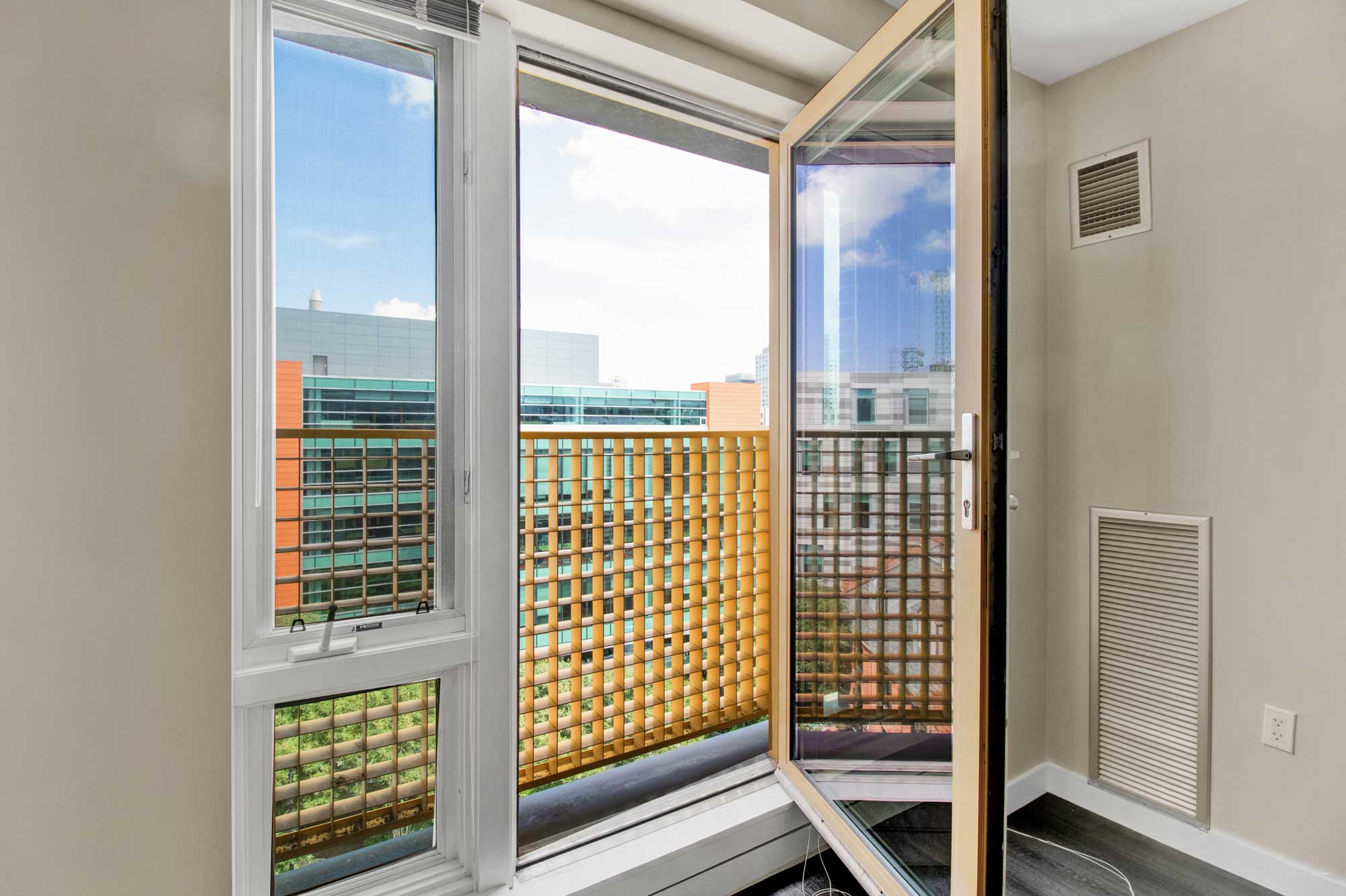 Close up of open living room window with city skyline views