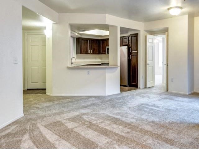 Ingleside Apartments Living Room with wall to wall carpet and kitchen by the front door