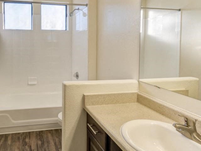 Ingleside Apartments Bathroom with hardwood style flooring and white countertops