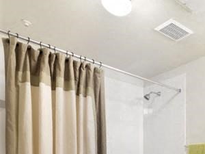 Bathroom with framed mirror, wood-style flooring, and soaking tub/shower