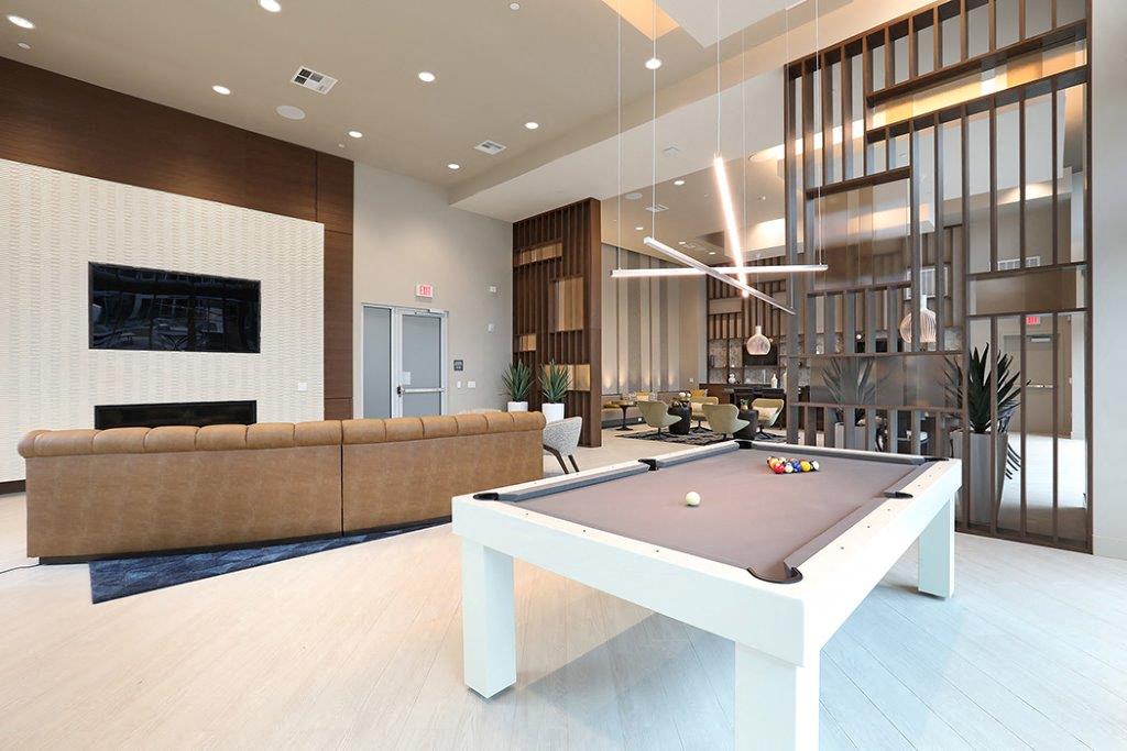 Pool table in the center of a living room at Eleven 10 in Orange, CA