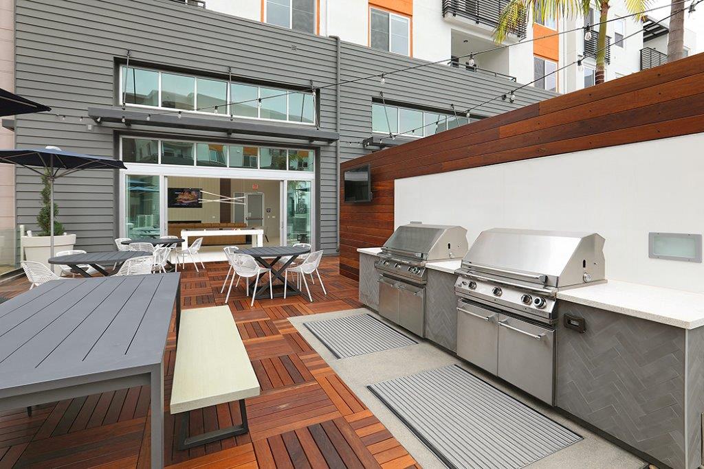 Outdoor patio with two stainless steel BBQ grills at Eleven 10 in Orange, CA