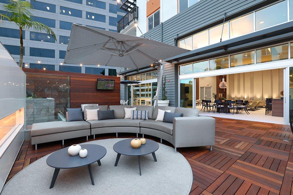 Outdoor patio with living room-style seating including a couch and tables