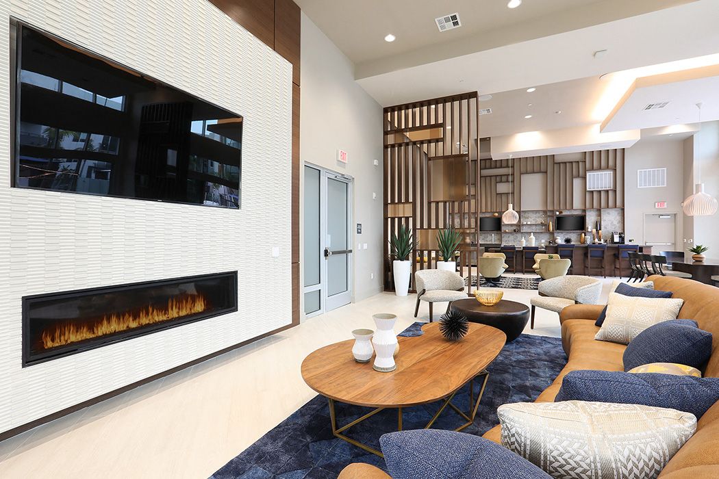 Living room with couches and fireplace at Eleven 10 in Orange, CA