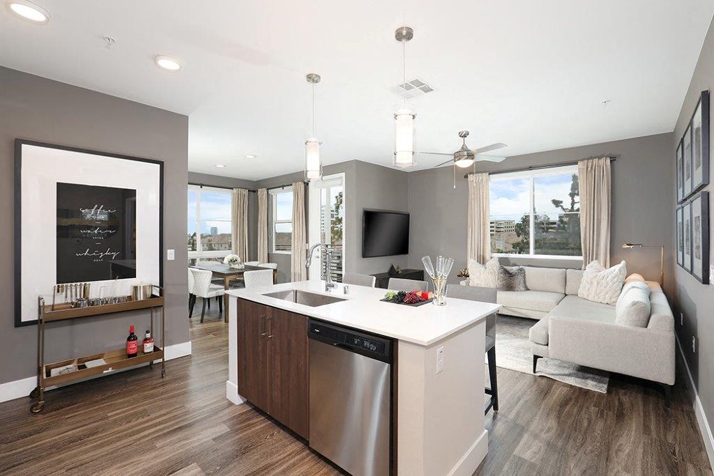 Living room with kitchen and television at Eleven 10 in Orange, CA